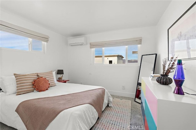 bedroom featuring a wall mounted air conditioner, multiple windows, and baseboards