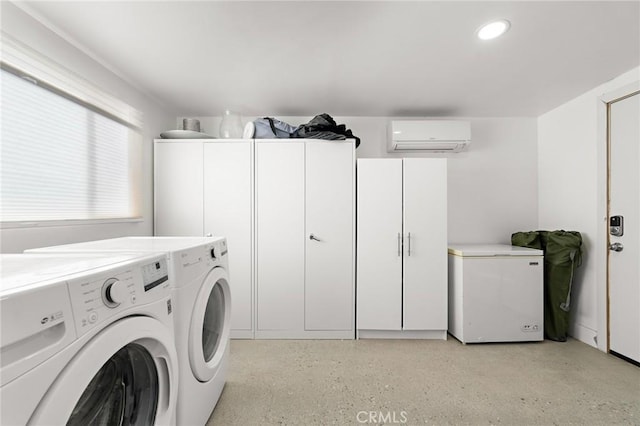 laundry room featuring recessed lighting, cabinet space, washing machine and dryer, and a wall mounted air conditioner