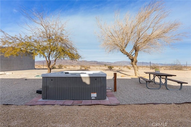 view of yard with central air condition unit, a mountain view, and a hot tub