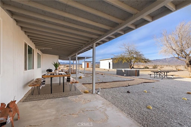 view of patio featuring a mountain view and an outdoor structure