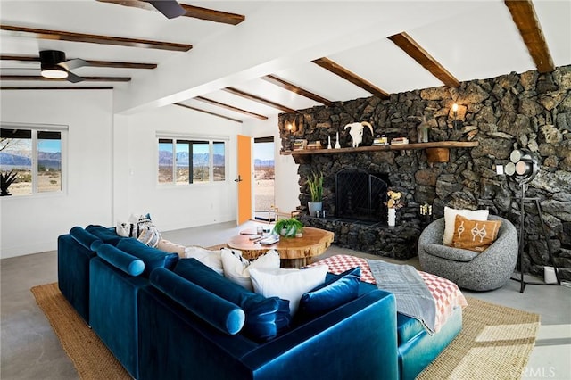 living room featuring a ceiling fan, finished concrete floors, a fireplace, and vaulted ceiling with beams