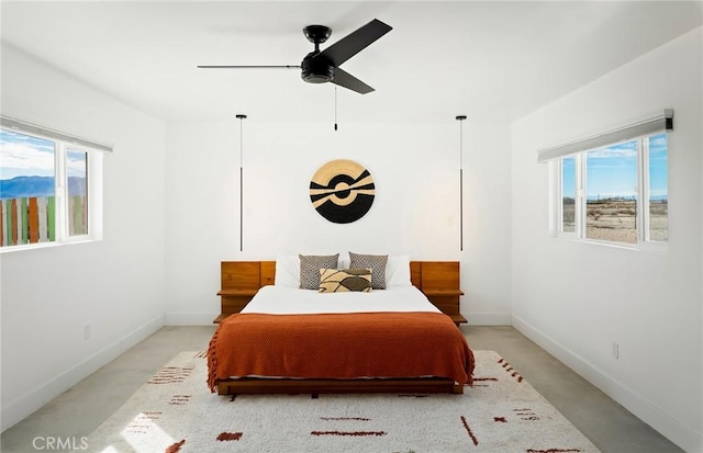 bedroom featuring multiple windows, a ceiling fan, and baseboards