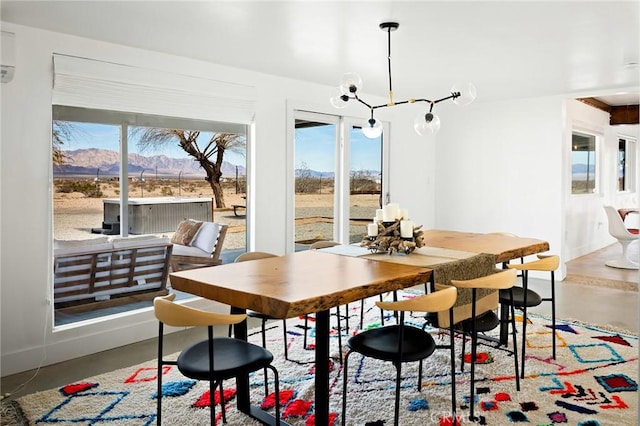 dining area featuring concrete floors and a mountain view