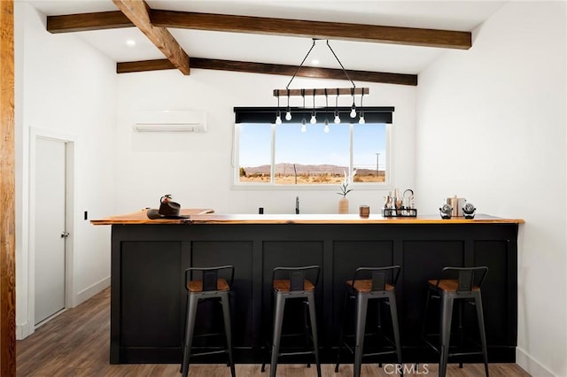 bar featuring an AC wall unit, dark wood finished floors, beam ceiling, and baseboards