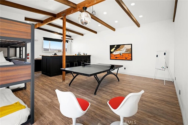 game room with baseboards, lofted ceiling with beams, bar, wood finished floors, and recessed lighting