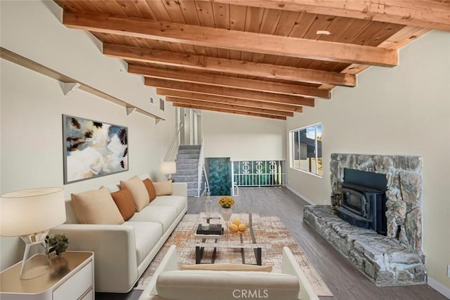 living room featuring beamed ceiling, stairway, wooden ceiling, and wood finished floors