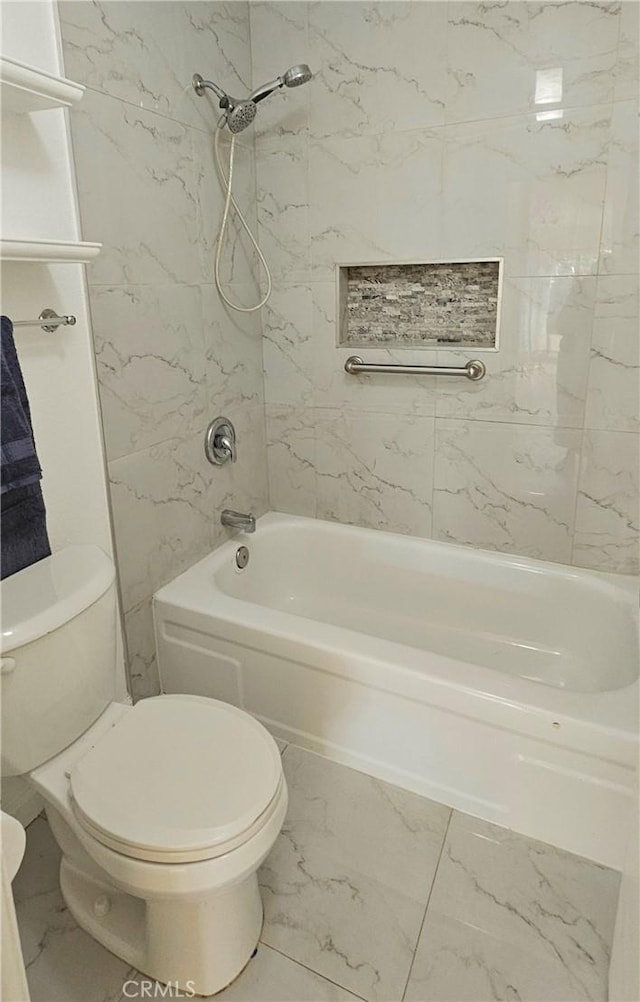 full bath with marble finish floor, tub / shower combination, and toilet