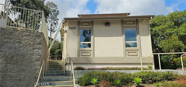 5440 Baltimore Dr Unit 144, La Mesa, CA 91942 - view of side of property featuring stucco siding and stairs