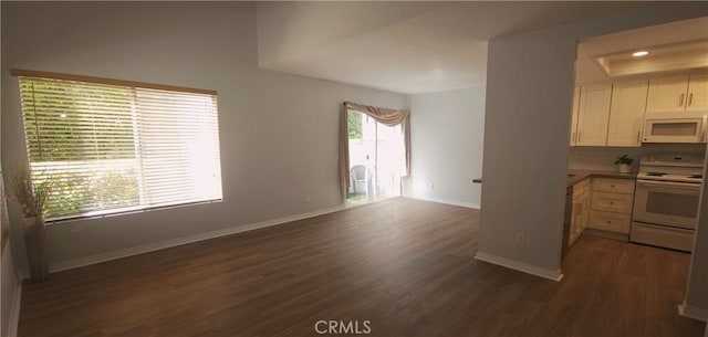 5440 Baltimore Dr Unit 144, La Mesa, CA 91942 - kitchen with white appliances, dark wood-style floors, baseboards, open floor plan, and white cabinets