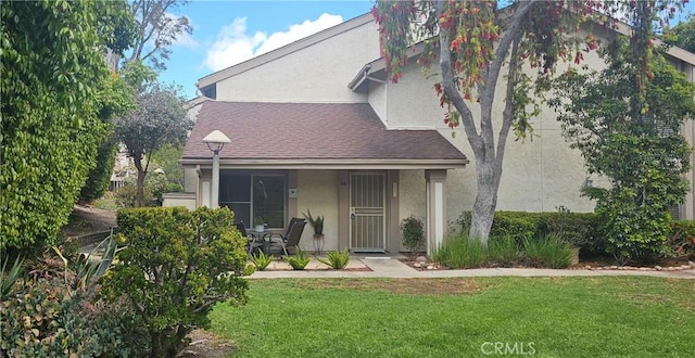 5440 Baltimore Dr Unit 144, La Mesa, CA 91942 - rear view of property featuring stucco siding, a lawn, covered porch, and roof with shingles