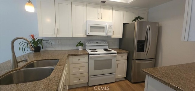 5440 Baltimore Dr Unit 144, La Mesa, CA 91942 - kitchen featuring white appliances, a sink, light wood finished floors, white cabinetry, and tasteful backsplash