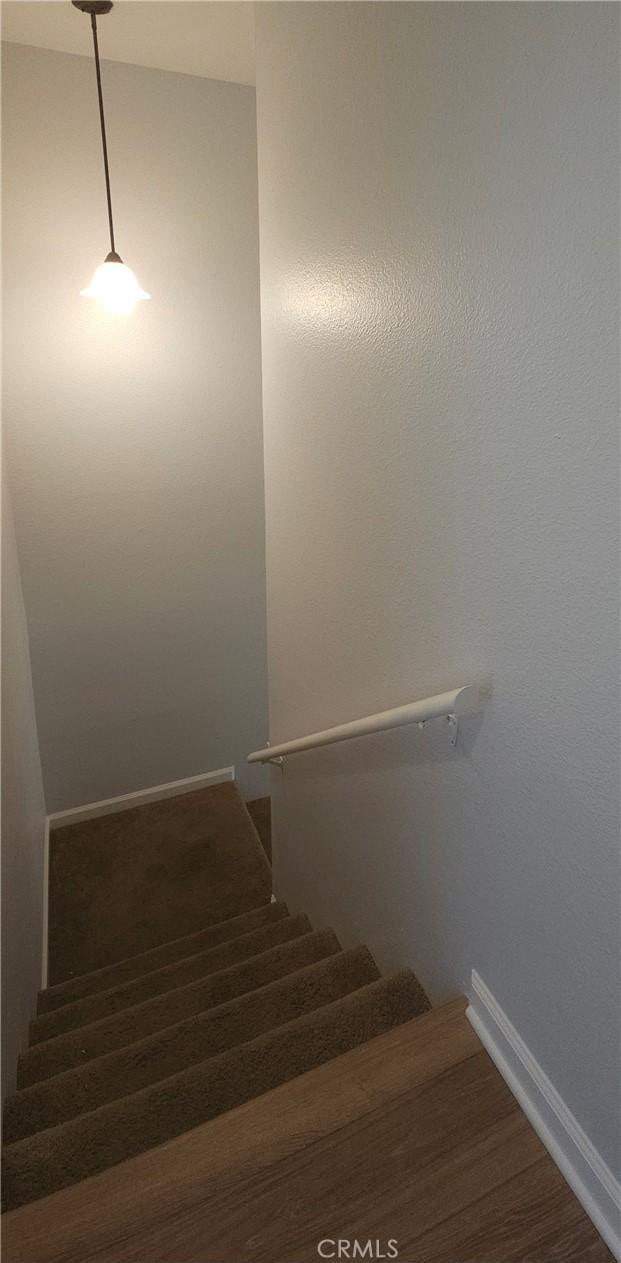 5440 Baltimore Dr Unit 144, La Mesa, CA 91942 - staircase featuring baseboards and wood finished floors