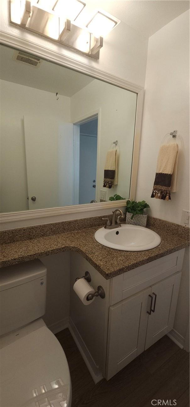 5440 Baltimore Dr Unit 144, La Mesa, CA 91942 - bathroom with vanity, wood finished floors, and toilet
