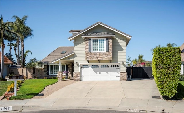 craftsman inspired home with concrete driveway, a gate, fence, stone siding, and a front lawn