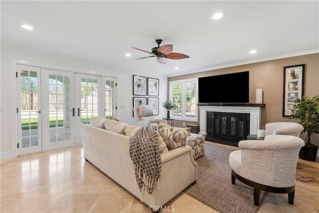 living area featuring a fireplace with flush hearth, recessed lighting, and french doors