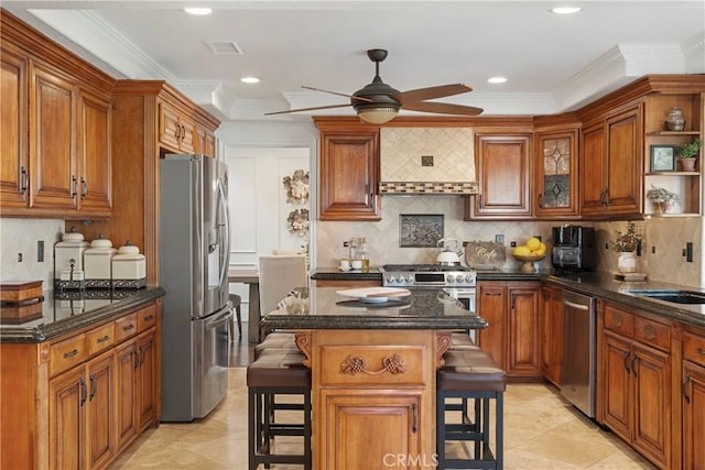 kitchen with a breakfast bar, brown cabinets, and stainless steel appliances