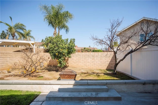 view of yard featuring an outdoor fire pit and a fenced backyard