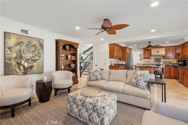 living room featuring stairs, ceiling fan, visible vents, and recessed lighting