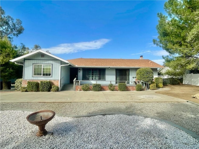 single story home featuring brick siding and driveway