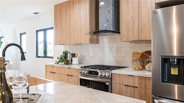 6652 Hough St, Los Angeles, CA 90042 - kitchen featuring wall chimney range hood, light countertops, appliances with stainless steel finishes, and modern cabinets