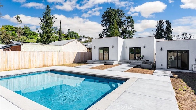 6652 Hough St, Los Angeles, CA 90042 - back of house with a patio area, a fenced in pool, fence, and stucco siding