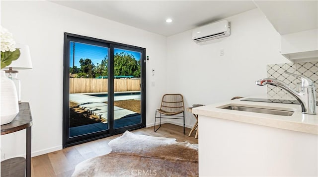 6652 Hough St, Los Angeles, CA 90042 - doorway featuring baseboards, a sink, an AC wall unit, recessed lighting, and light wood-style flooring