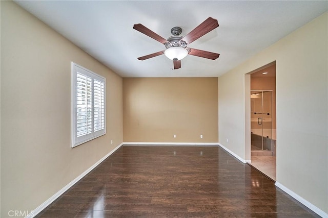 empty room featuring ceiling fan, baseboards, and wood finished floors