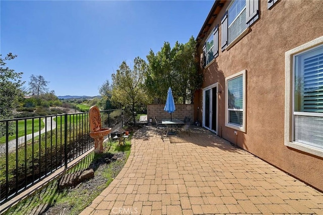 view of patio featuring fence