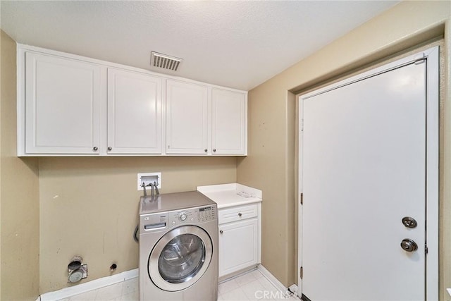 clothes washing area with washer / dryer, cabinet space, baseboards, visible vents, and light tile patterned flooring