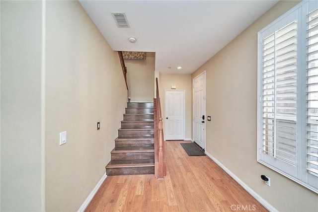 interior space with baseboards, visible vents, and wood finished floors