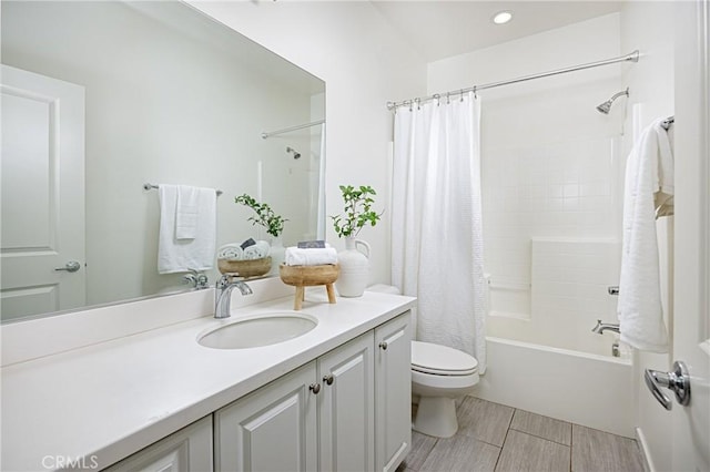 bathroom featuring shower / bath combo, vanity, and toilet