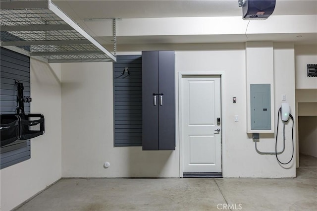 garage featuring electric panel and a garage door opener