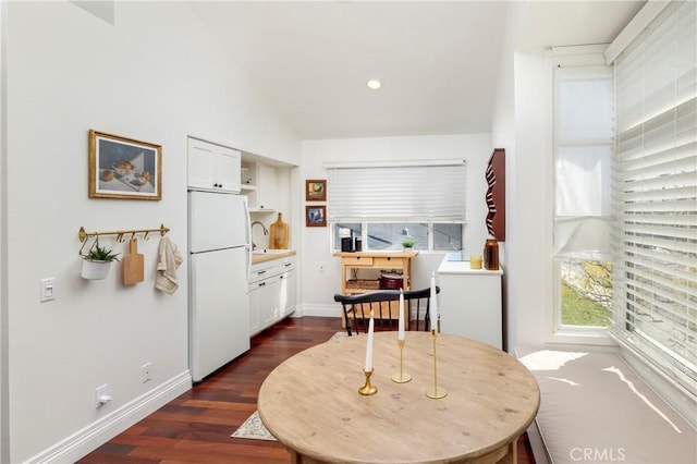 dining area with recessed lighting, dark wood-style flooring, vaulted ceiling, and baseboards