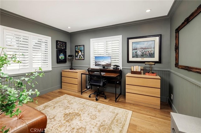 office area featuring ornamental molding, light wood finished floors, and wainscoting