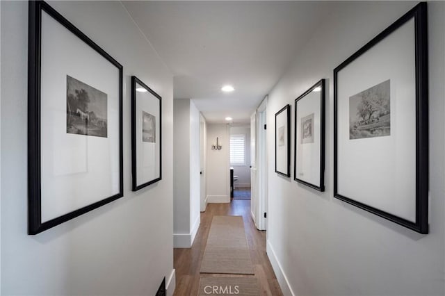 hall with recessed lighting, baseboards, and wood finished floors