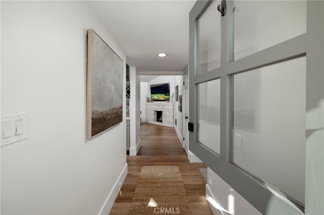 hall with baseboards, wood finished floors, and recessed lighting