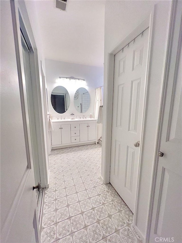 full bath with double vanity, tile patterned flooring, and visible vents