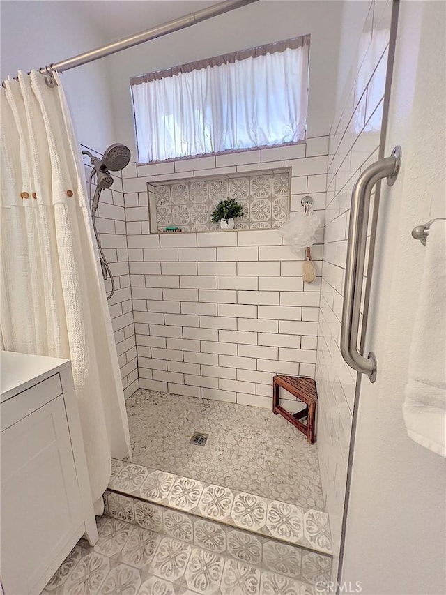 full bathroom featuring a stall shower, tile patterned flooring, and vanity