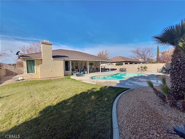 view of swimming pool featuring a fenced in pool, a fenced backyard, a lawn, and a patio