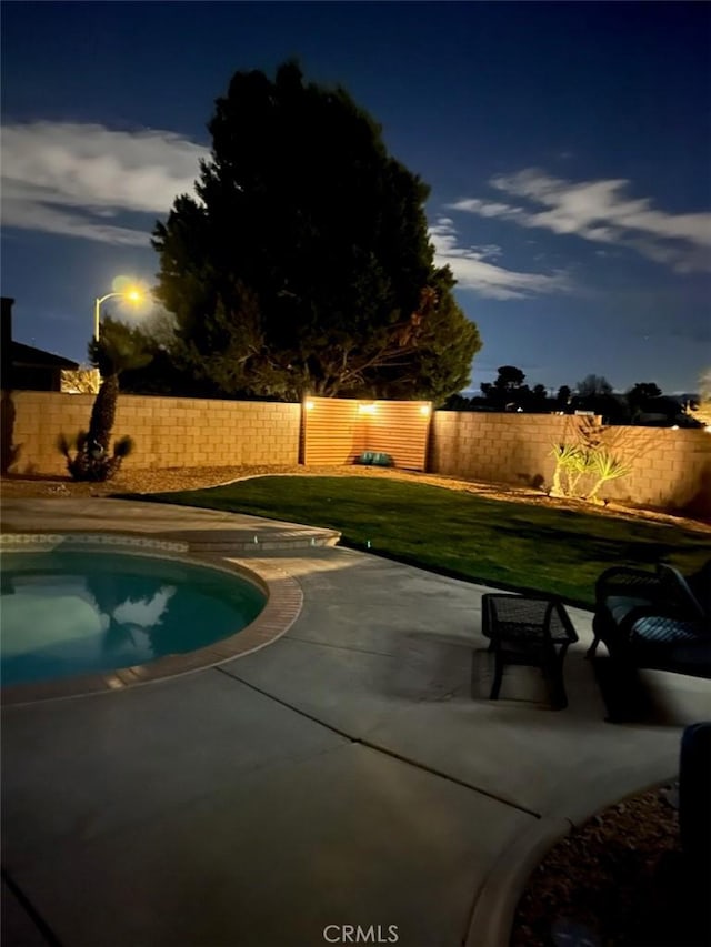 view of pool featuring a patio, a lawn, a fenced backyard, and a fenced in pool