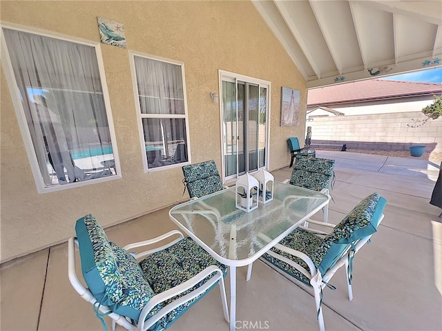 view of patio with outdoor dining area and fence