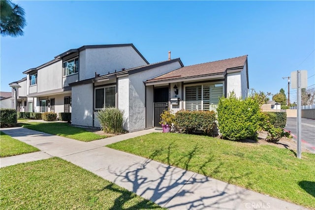 view of front of house featuring a front yard and stucco siding