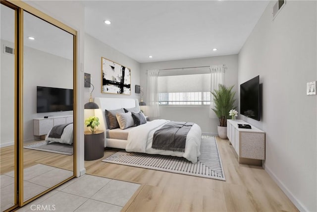 bedroom featuring a closet, wood finished floors, and visible vents