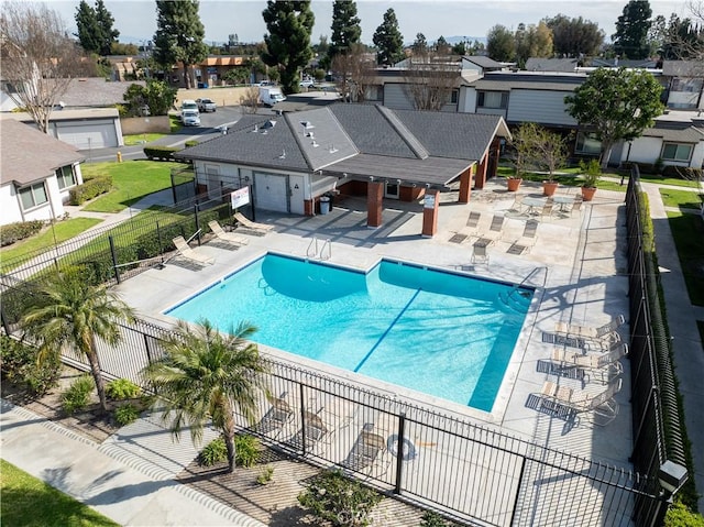 pool with a residential view, fence, and a patio