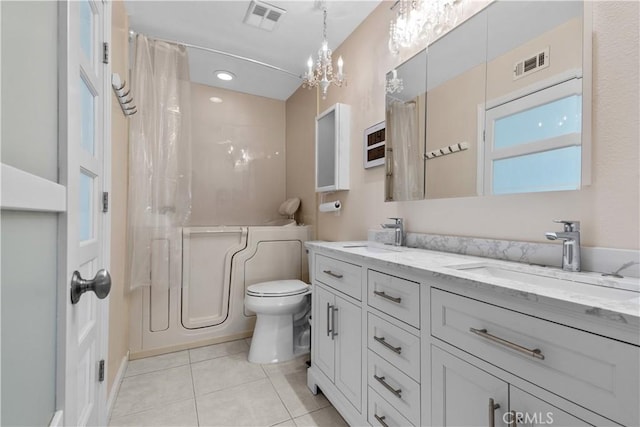 bathroom featuring tile patterned flooring, visible vents, and a sink