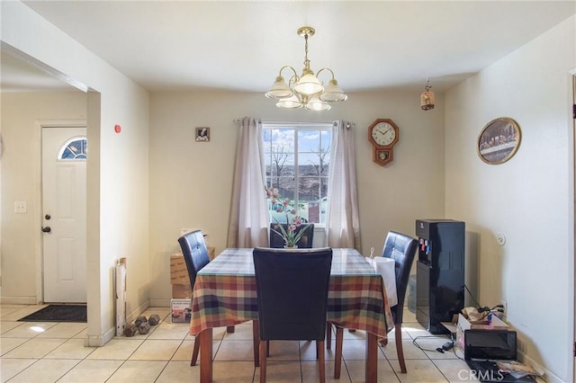 dining room with light tile patterned floors, a chandelier, and baseboards