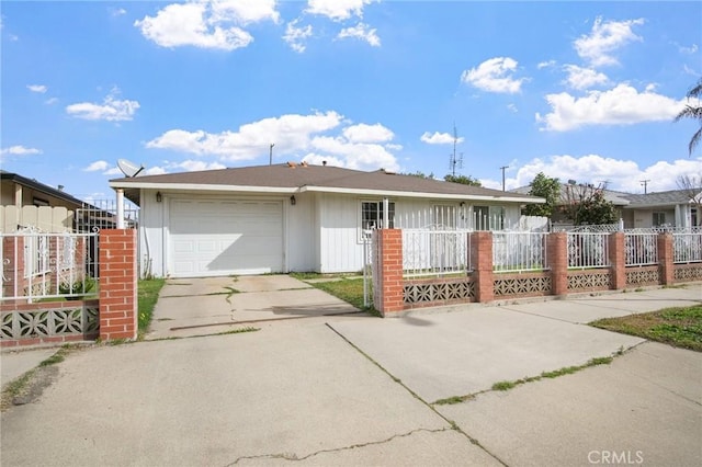 single story home featuring driveway, a fenced front yard, and an attached garage