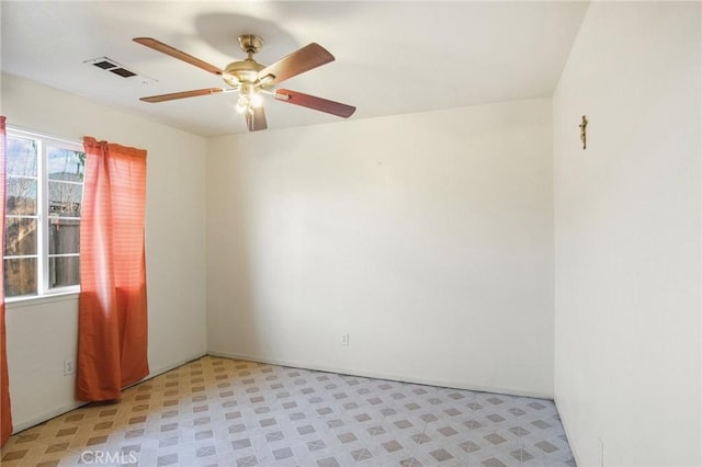 empty room with light floors, ceiling fan, and visible vents