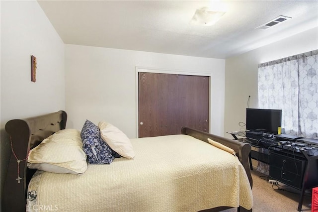 bedroom featuring a closet, carpet flooring, and visible vents