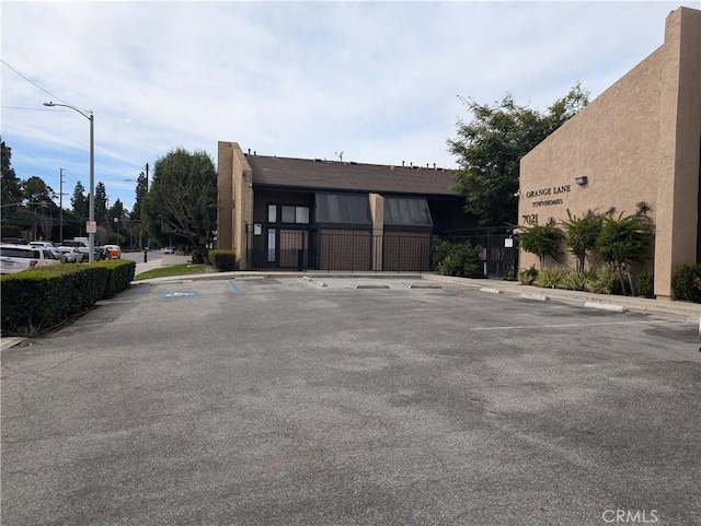 view of building exterior with uncovered parking